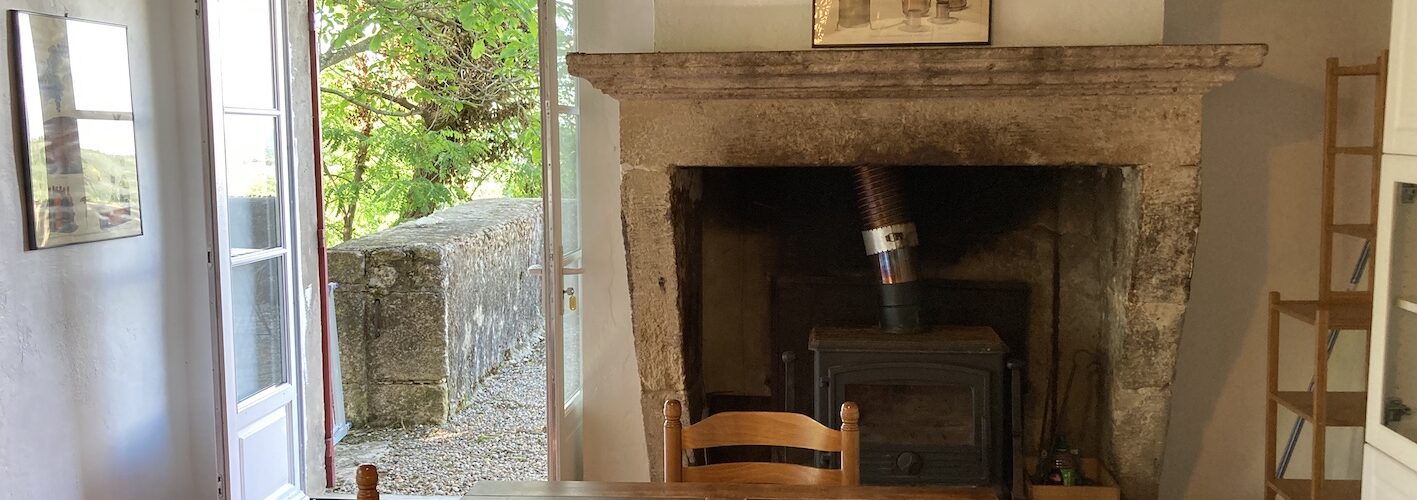 Gite kitchen fireplace, terrace door